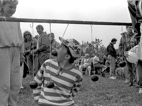 Jenny Stein, 10, of Leamington plays the apple string game at the apple festival on Sept. 30, 1990. (FILES/The Windsor Star)