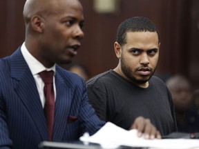 Christopher Cruz, right, appears in criminal court with his lawyer H. Benjamin Perez in New York, Wednesday, Oct. 2, 2013. Cruz, 28, of New Jersey, was charged Wednesday with reckless driving after prosecutors said he touched off a tense encounter with the driver of a sport utility vehicle and a throng of other bikers that ended with blood and broken bones on a Manhattan street. He was also charged with unlawful imprisonment. His bail was set at $1,500 cash. (/Seth Wenig/Associated Press)