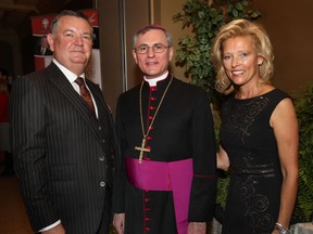 Bishop Ronald Fabbro, centre, poses with John and Pam Rodzik at the 10th annual Bishop's Dinner at the Ciociaro Club on Wednesday, Oct. 30, 2013. (Dan Janisse/The Windsor Star)