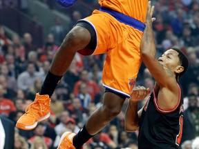 Knicks guard Tim Hardaway Jr., left, drives to the basket against Bulls guard Derrick Rose in Chicago, Thursday, Oct. 31, 2013. (AP Photo/Nam Y. Huh)