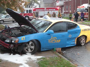 Windsor firefighters and Windsor-Essex EMS paramedics worked to free the driver of a taxi following an accident with a pickup truck on Assumption Street and Marentette Avenue in Windsor, Ontario on October 31, 2013.   The exact extent of injuries were not known at the scene.  Windsor Police are investigating.  (JASON KRYK/The Windsor Star)_