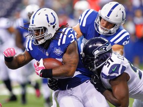 Trent Richardson, left, of the Indianapolis Colts runs the ball against Chris Clemons #91 of the Seattle Seahawks at Lucas Oil Stadium on October 6, 2013 in Indianapolis. (Michael Hickey/Getty Images)