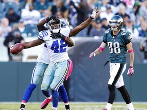 Dallas safety Barry Church, front left, celebrates an interception with teammate Morris Claiborne as Philadelphis wide receiver Jeff Maehl looks on at Lincoln Financial Field on October 20, 2013 in Philadelphia. The Cowboys face the Lions Sunday in Detroit. (Rich Schultz /Getty Images)