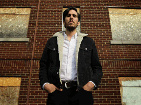 Dan Griffin stands in front of a boarded up building in the Indian Road area of Windsor on Tuesday, October 29, 2013. Griffin is a Hamilton-born singer who is studying law at the University of Windsor. His song, Bordertown, refers to the Ambassador Bridge and the "rundown" neighbourhoods of Windsor.          (TYLER BROWNBRIDGE/The Windsor Star)