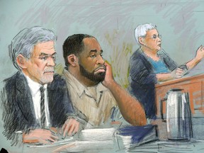 In this courtroom sketch, former Detroit Mayor Kwame Kilpatrick, sits between his attorneys Harold Gurewitz, left, and Margaret Raben before federal Judge Nancy Edmunds during his sentencing in federal court on Thursday, Oct. 10, 2013, in Detroit. Kilpatrick was sentenced to 28 years in prison for corruption, after a series of scandals destroyed his political career and helped steer a crisis-laden city even deeper into trouble. (AP Photo/Jerry Lemenu)