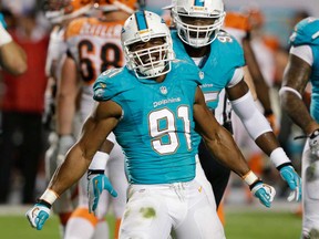 Dolphins defensive end Cameron Wake celebrates after he recovered a fumble by Cincinnati Bengals quarterback Andy Dalton during the first half Thursday, Oct. 31, 2013, in Miami Gardens, Fla. (AP Photo/Wilfredo Lee)