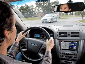 A woman sits at the wheel of a Ford Fusion. (Postmedia file photo)