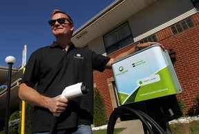 Christopher Misch, vice-president of Sun Country Highway, with one his company's charging stations at the Comfort Inn in Windsor. (TYLER BROWNBRIDGE / The Windsor Star)