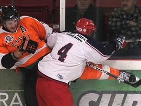 Essex's Dylan Solecki, left, takes a hit from Alvinston's Clint Rose during their game Tues. Oct. 29, 2013, in Essex, Ont.  (DAN JANISSE/The Windsor Star)