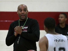 Windsor Express head coach Bill Jones, left, talks with Darren Duncan during the team's first official practice of the new season at Rose City Islamic Centre October 21, 2013.  (NICK BRANCACCIO/The Windsor Star)