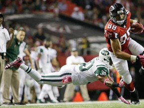 Falcons tight end Tony Gonzalez, right, runs past New York's Darrin Walls during the second half Monday, Oct. 7, 2013, in Atlanta. (AP Photo/David Goldman)