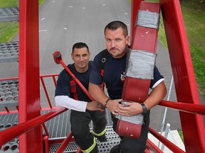 Tecumseh Fire and Rescue Service firefighters Basem Baalbaki (L) and Dan Redmond pose Monday, Oct. 21, 2013, at the station on Walker Rd. just north of highway 3. They are headed to the Scott Safety Firefighter Combat Challenge in Las Vegas this week as part of a Windsor/Tecumseh team.  (DAN JANISSE/The Windsor Star)