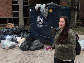 Fifth-year University of Windsor student Alyssa Lasalandra walks past an overflowing garbage bin at the University of Windsor campus on October 7, 2013 in Windsor, Ontario on October 7, 2013. (JASON KRYK/The Windsor Star)