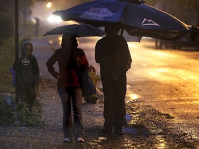 Umbrellas were mandatory Thurs. Oct. 31, 2013, on a rainy Halloween night. This family walks along Victoria Ave. in Windsor, Ont. (DAN JANISSE/The Windsor Star)