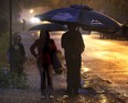 Umbrellas were mandatory Thurs. Oct. 31, 2013, on a rainy Halloween night. This family walks along Victoria Ave. in Windsor, Ont. (DAN JANISSE/The Windsor Star)