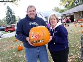Roch and Rachelle Ethier hold up a pumpkin that was carved for the memory of their 14-year-old son who died from cancer in June. Pumpkins for Daniel was started with friends and family to bring a carved pumpkin to honour his memory of his favourite time of the year: Halloween. (JOEL BOYCE/The Windsor Star)
