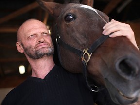 Mark Williams, Lakeshore Horse Racing Association president and director of the Ontario Horseman Harness Association, is pictured Stonebridge Storm at his home, Friday, Oct. 11, 2013.  (DAX MELMER/The Windsor Star)