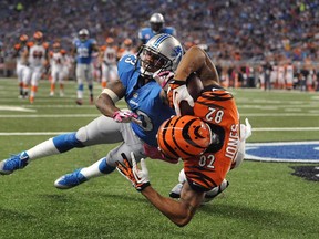 Cincinnati's Marvin Jones, left, catches a 12-yard touchdown as Detroit's Chris Houston defends in the second quarter Sunday, Oct. 20, 2013, in Detroit. (AP Photo/Jose Juarez)