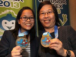 Karmen Lo, (L) and her aunt Venus Lee, both volunteers with the games proudly display their medals.   (DAN JANISSE/The Windsor Star)