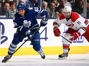 Toronto's Dave Bolland, left, skates away from Carolina's Jordan Staal at the Air Canada Centre October 17, 2013 in Toronto, Ontario, Canada.  (Photo by Abelimages/Getty Images)