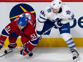 Toronto's Phil Kessel, right, battles Montreal's David Desharnais during first period Tuesday, October 1, 2013 in Montreal. THE CANADIAN PRESS/Ryan Remiorz