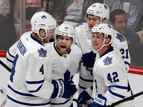 Toronto's James van Riemsdyk, second from right, celebrates a goal with teammates Cody Franson, left, Phil Kessel, centre, and Tyler Bozak against the Montreal Canadiens during first period National Hockey League action Tuesday, October 1, 2013 in Montreal. THE CANADIAN PRESS/Ryan Remiorz