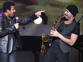 Lionel Richie, left, sings onstage while sax player Dino Soldo belts out a tune on Thurs. Oct. 3, 2013, at the Colosseum at Caesars Windsor. (DAN JANISSE/The Windsor Star)