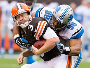 Cleveland quarterback Brandon Weeden, left, is sacked by Detroit defensive tackle Ndamukong Suh Sunday, Oct. 13, 2013 in Cleveland. The Lions beat the Browns 31-17. (Jason Miller/Getty Images)