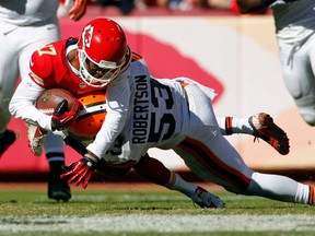 Kansas City wide receiver Donnie Avery, top, is tackled by Cleveland linebacker Craig Robertson in Kansas City, Mo., Sunday, Oct. 27, 2013. (AP Photo/Colin E. Braley)