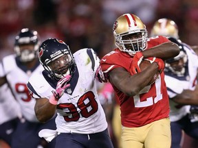 San Francisco's Frank Gore, right, runs past Danieal Manning in the second half at Candlestick Park on October 6, 2013 in San Francisco, California. The 49ers defeated the Texans 34-3.  (Jeff Gross/Getty Images)