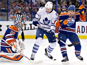 Toronto winger James van Riemsdyk, centre, and Edmonton defenceman Andrew Ference, right, battle in front of Oilers goalie Richard Bachman in Edmonton on Tuesday, October 29, 2013. (THE CANADIAN PRESS/Jason Franson)