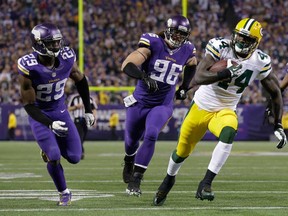 Packers running back James Starks, right, rushes past Minnesota's Xavier Rhodes, left, and Brian Robison for a touchdown Sunday, Oct. 27, 2013, in Minneapolis. (AP Photo/Jim Mone)