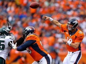 Broncos QB Peyton Manning, right, throws a pass against the Philadelphia Eagles at Sports Authority Field Field at Mile High on September 29, 2013 in Denver, Colorado.  (Photo by Justin Edmonds/Getty Images)