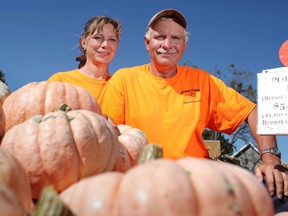 Chris Allsop, and his wife, Debbie Allsop, left, are selling pink pumpkins at their farm, Allsop Farm, Pumpkins and More, in Kingsville, Ont., Friday, Ont. 11, 2013.  One dollar from the sale of each pumpkin will be donated to breast cancer research.  (DAX MELMER/The Windsor Star)