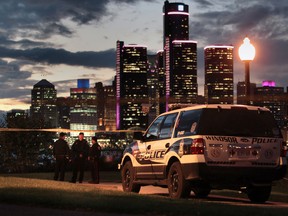 Windsor Police officers are seen along the Detroit River during an investigation at Riverside Drive east near Pierre Avenue in Windsor, Ontario.  (JASON KRYK/The Windsor Star)