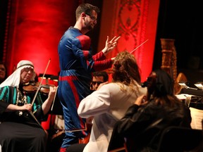 Conductor Jason Seber, dressed in a Spiderman costume, conducts during the Windsor Symphony Orchestra's Halloween Pops at the Capitol Theatre, Friday, Oct. 25, 2013.   (DAX MELMER/The Windsor Star)