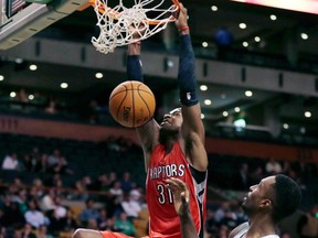 Raptors guard Terrence Ross, left, dunks in front of Boston Celtics forward Jeff Green during pre-season NBA action Monday, Oct. 7, 2013, in Boston. The Raptors defeated the Celtics 97-89. (AP Photo/Charles Krupa)