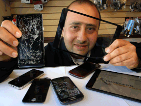 Sam Maktabi holds a replacement digitizer for a mini iPad in his left hand while displaying a broken cell phone in his right at Wireless Warehouse on Tecumseh Road East in Windsor.  (NICK BRANCACCIO/The Windsor Star)