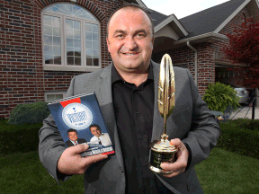 Windsor real estate broker Sasha Miletic at his home with a book for which he wrote a chapter.  (DAN JANISSE/The Windsor Star)