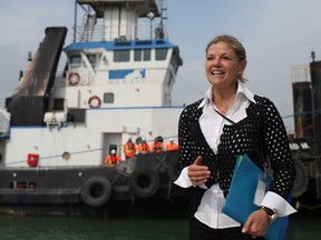 Kathy McKeil, director of corporate communications for McKeil Marine Ltd., speaks in front of the tugboat, the Leonard M, which was christened along with a newly added barge, the Huron Spirit, at the Port of Windsor on Friday. (DAX MELMER / The Windsor Star)