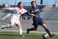 Windsor's Jaclyn Faraci, right, battles Brock's Alex Crawford during OUA woman's soccer action at Alumni Field, Sunday, Oct. 13, 2013. The Lancers open the playoffs Wednesday in Guelph. (DAX MELMER/The Windsor Star)