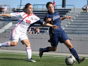 Windsor's Jaclyn Faraci, right, battles Brock's Alex Crawford during OUA woman's soccer action at Alumni Field, Sunday, Oct. 13, 2013. The Lancers open the playoffs Wednesday in Guelph. (DAX MELMER/The Windsor Star)