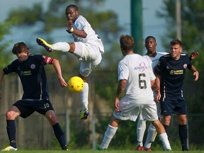 Windsor's Stephen Ademolu, centre, battles for the ball against Toronto Croatia in Canada Soccer League action at Windsor Stadium in June 30. The Stars open the CSL playoffs Saturday against the reigning champs in Toronto.  (DAX MELMER/The Windsor Star)