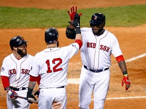 Boston's David Ortiz, right, celebrates with Mike Napoli, centre, and Dustin Pedroia after hitting a home run in the seventh inning against the St. Louis Cardinals during Game 1 of the 2013 World Series at Fenway Park on October 23, 2013 in Boston.  (Jared Wickerham/Getty Images)