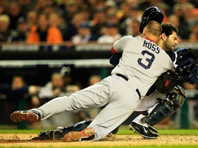 Boston's David Ross, left, is tagged out at home by Detroit's Alex Avila in the second inning of Game 5 of the American League Championship Series at Comerica Park on October 17, 2013 in Detroit. (Jamie Squire/Getty Images)