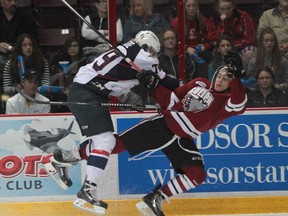 Guelph's Tyler Bertuzzi, right, collides with Windsor's Ty Bilcke during first-period OHL action at the WFCU Centre in Windsor on October 17, 2013. The Storm beat the Spitfires 3-2. (JASON KRYK/The Windsor Star)