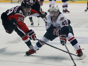 Windsor's Ryan Moore, right, battles Niagara's Aleksandar Mikulovich in OHL action at the WFCU Centre, Sunday, Oct. 6, 2013. The Spitfires beat the IceDogs 7-4. (DAX MELMER/The Windsor Star)