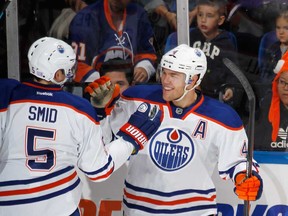 Edmonton's Taylor Hall, right, celebrates his second goal of the first period at the 16:00 minute mark against the New York Islanders at the Nassau Veterans Memorial Coliseum on October 17, 2013 in Uniondale, New York.  (Photo by Bruce Bennett/Getty Images)