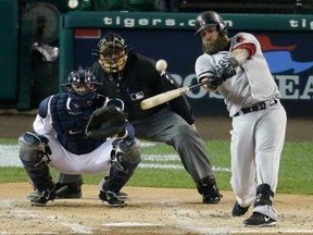 Boston's Mike Napoli, right, hits a home run in the second inning during Game 5 of the American League Championship Series against the Detroit Tigers, Thursday, Oct. 17, 2013, in Detroit. (AP Photo/Charlie Riedel)