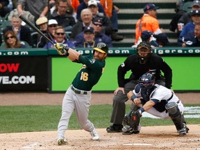 Oakland's Josh Reddick connects for a solo home run during the fourth inning of Game 3 of an American League baseball division series against the Detroit Tigers in Detroit, Monday, Oct. 7, 2013. (AP Photo/Charles Rex Arbogast)